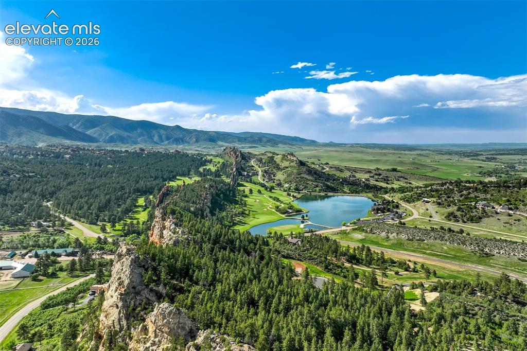 Image 48 of 48: Expansive natural landscape featuring lush green trees, rugged rock formati