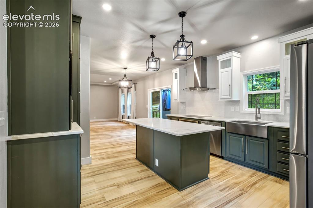 Image 5 of 48: Recently renovated kitchen featuring an expansive center island, stainless 