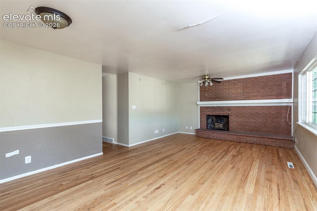 Image 11 of 37: Main Level - Hardwood Flooring - Brick Facade Wood Burning Fireplace