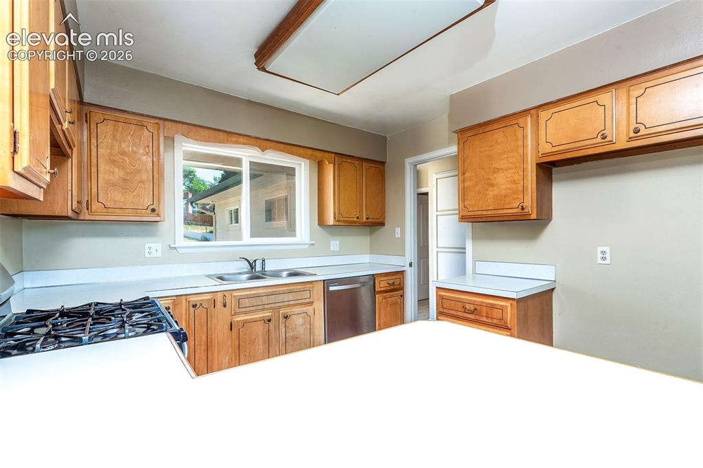 Image 13 of 37: Cabinets could use refresh or replacement. Some Counterop Damage