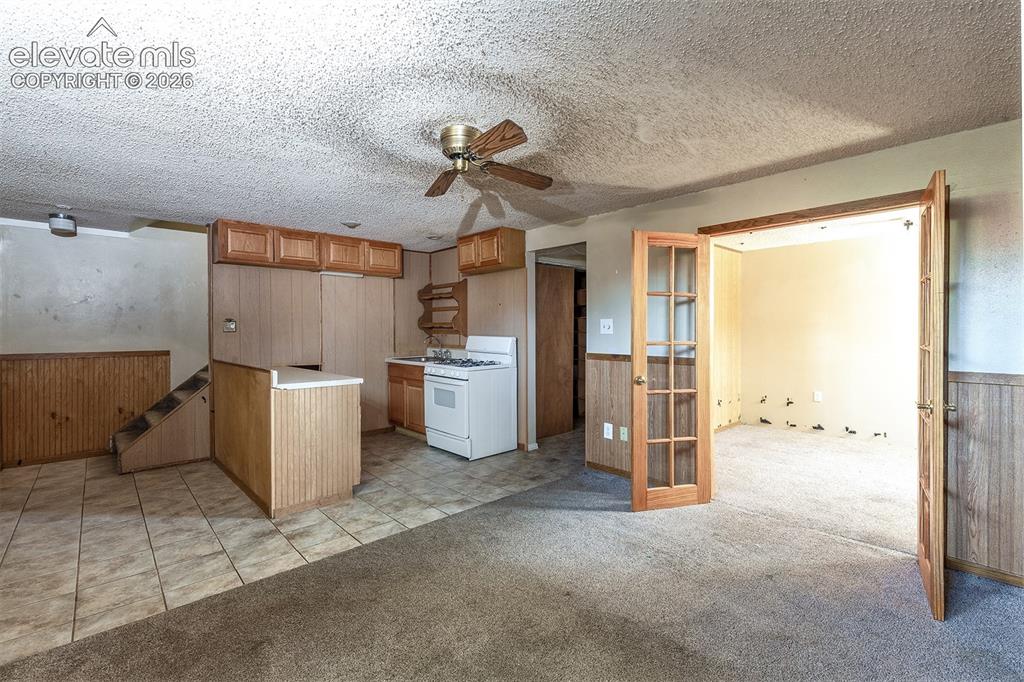 Image 23 of 37: Basement Level Family Room - Office Access - through French Doors - Carpet