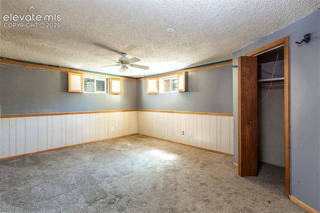 Image 29 of 37: Basement Bedroom #5 - Carpet needs replacement