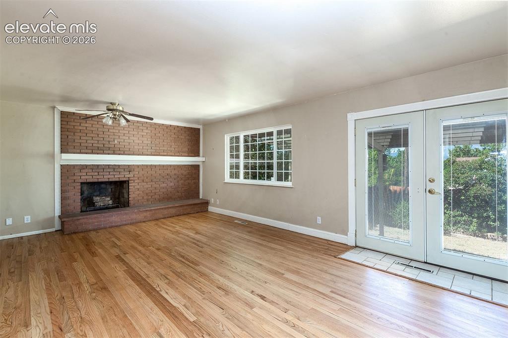Image 7 of 37: Double French Doors - Wood Burning Fireplace - Hardwood Floorig