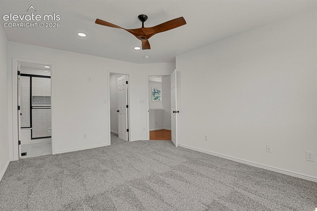 Image 25 of 49: Spacious room featuring light gray carpeting and white walls