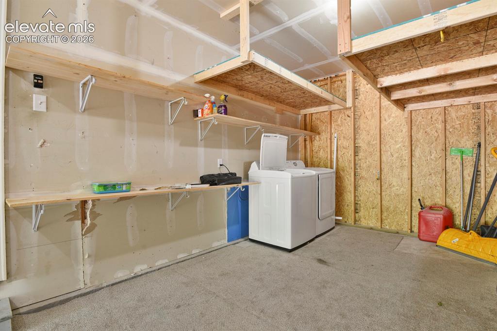 Image 41 of 49: Functional garage space featuring a concrete floor