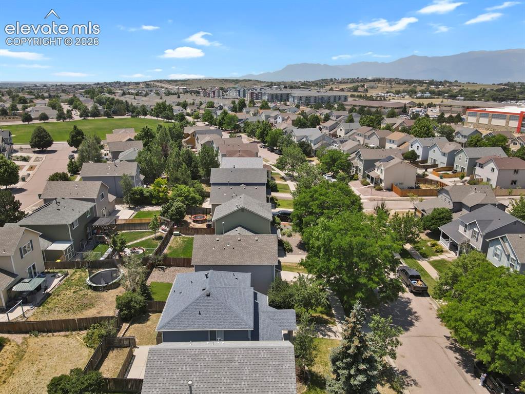 Image 45 of 49: Aerial overview of a residential neighborhood with varied architectural sty