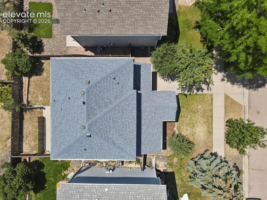Image 47 of 49: Property featuring a gray shingle roof, a concrete driveway, and a partiall