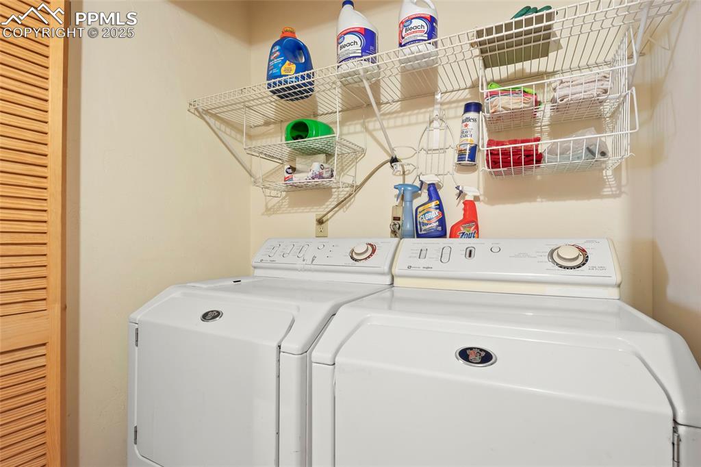 Image 11 of 33: Laundry room with washing machine and clothes dryer