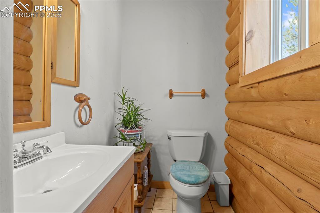 Image 6 of 33: Bathroom featuring vanity and light tile patterned floors