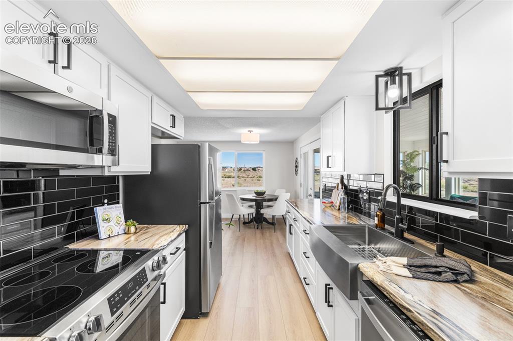 Image 11 of 44: Full view of the kitchen with new custom cabinets with soft close, new coun