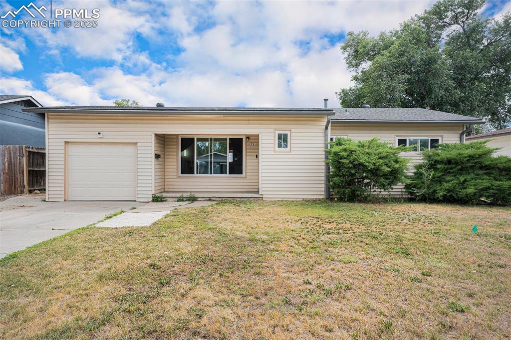 Caption: Single story home featuring driveway and a garage