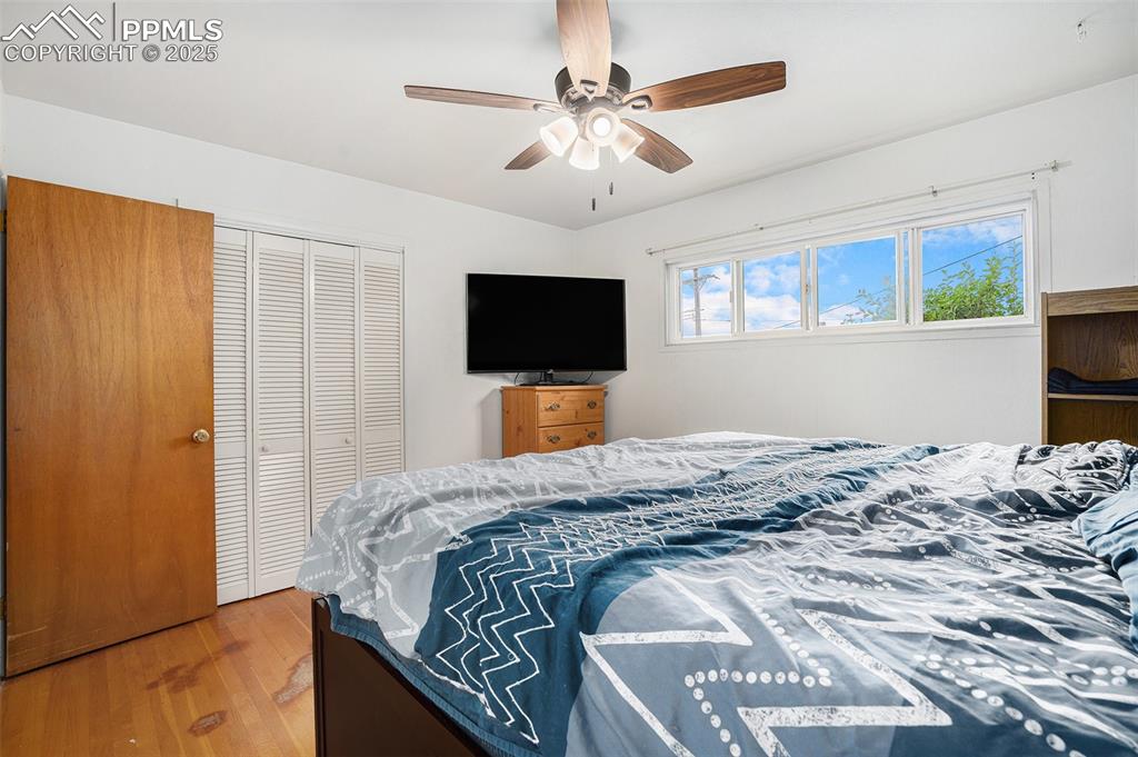 Image 17 of 30: Bedroom featuring a closet, wood finished floors, and ceiling fan