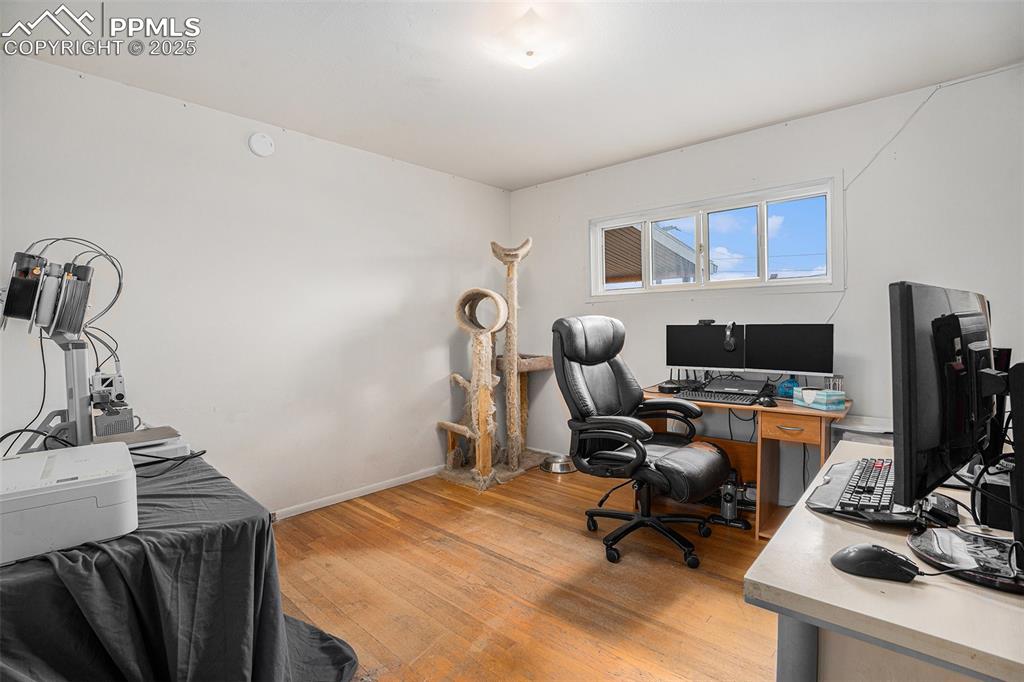 Image 18 of 30: Home office with light wood-style flooring and baseboards
