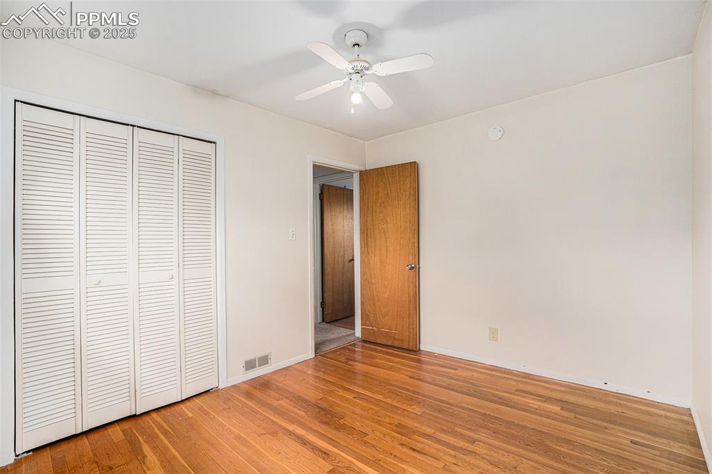 Image 21 of 30: Unfurnished bedroom with light wood-style flooring, a closet, and ceiling f