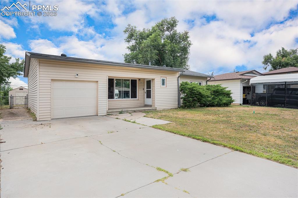 Image 4 of 30: Single story home with driveway, an attached garage, and a gate