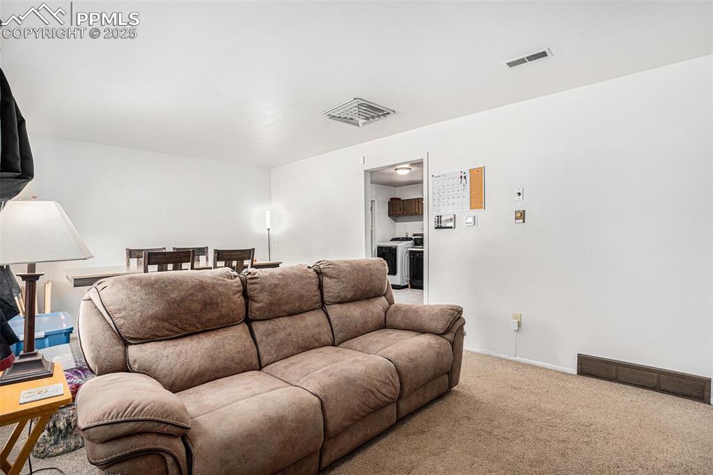 Image 7 of 30: Home theater featuring carpet and washer / dryer