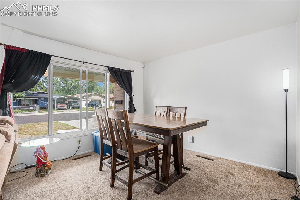 Image 8 of 30: Carpeted dining space featuring baseboards