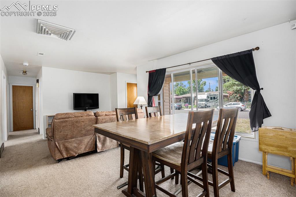 Image 9 of 30: Dining room with light carpet