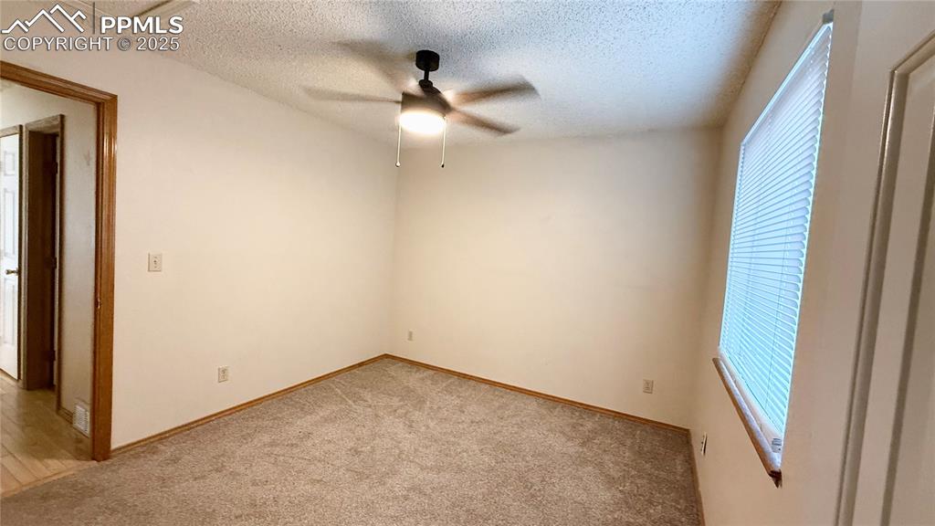 Image 6 of 16: Spare room featuring healthy amount of natural light, a ceiling fan, light 