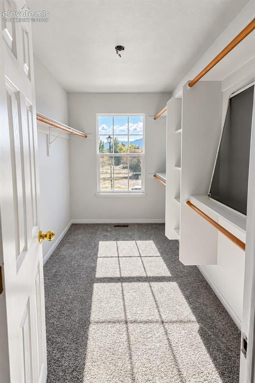 Image 14 of 32: Walk-in Closet in Primary Bedroom Suite