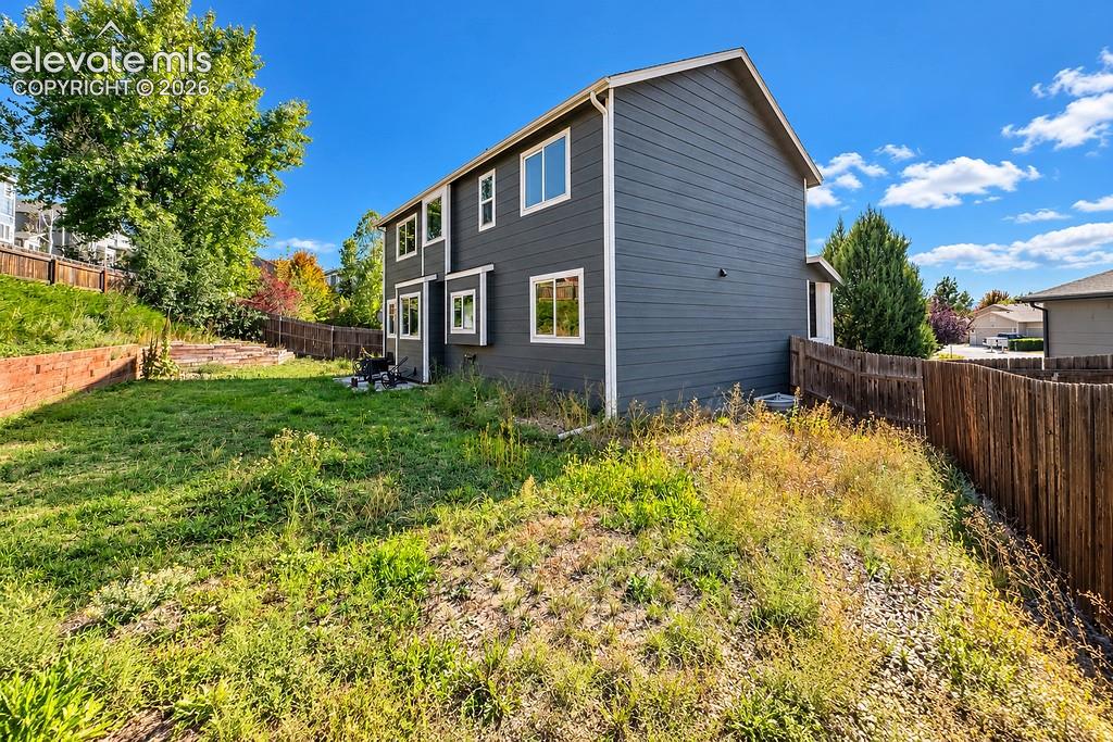 Image 29 of 32: Two-story residence featuring horizontal lap siding, white trim detailing, 