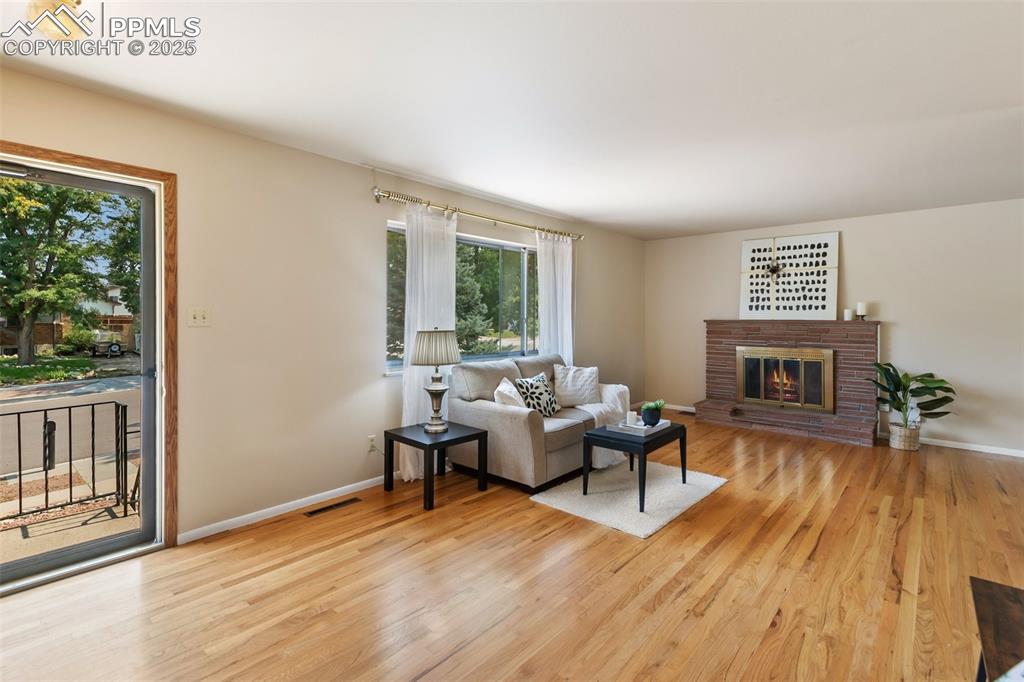 Image 15 of 49: Living room with woodburning fireplace