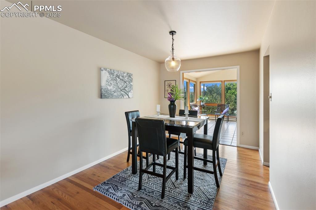 Image 19 of 49: Dining room walks into sunroom