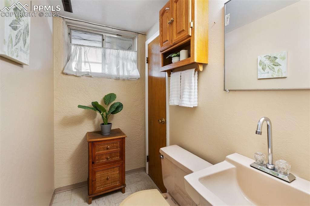 Image 41 of 49: Downstairs half bath - could easily be a 3/4