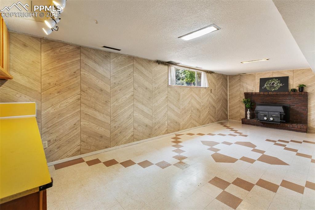 Image 43 of 49: Schrager woodburning stove in downstairs family room