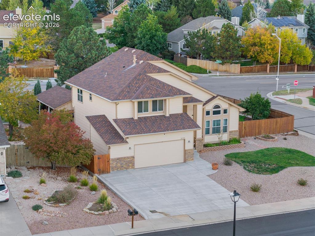 Image 1 of 49: Two-story residence featuring composite shingle roofing, light-toned horizo