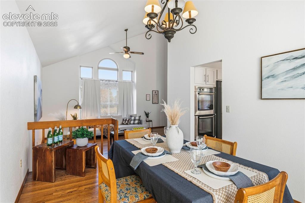 Image 13 of 49: Vaulted ceilings, expansive arched windows, wood-finish flooring, ornate ir