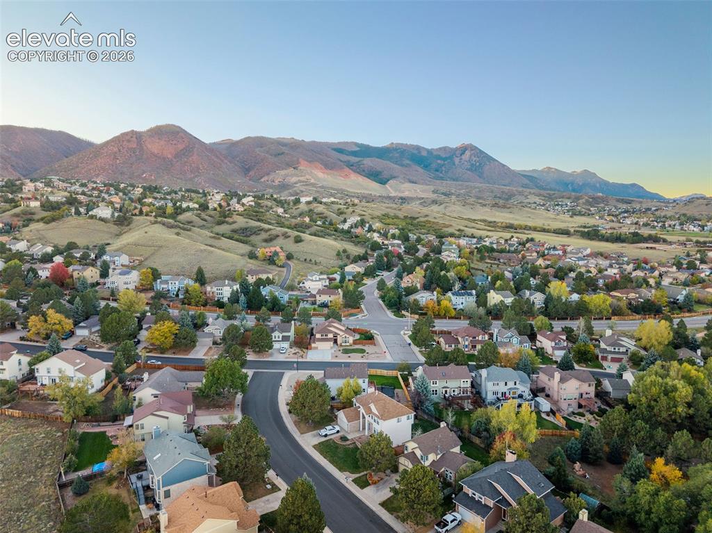 Image 49 of 49: Aerial perspective of residential neighborhood featuring paved streets and