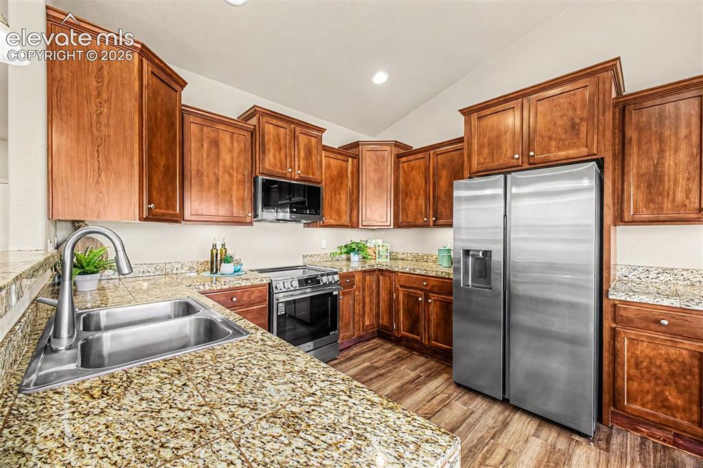 Image 10 of 44: Kitchen features new stainless steel smart appliances, under cabinet lighti