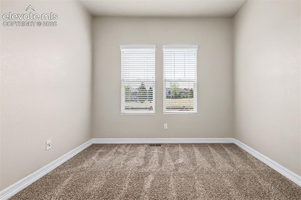 Image 18 of 44: Front bedroom is perfect for guests or a home office