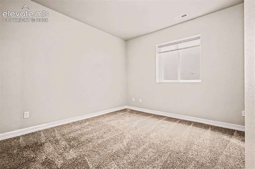 Image 22 of 44: Flexible space makes for a good home gym, office, or family room