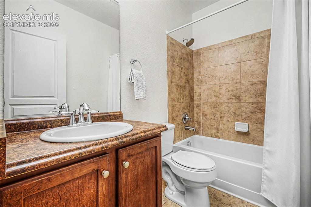 Image 24 of 44: Fourth bedroom is located in the basement and includes a nearby full bathro