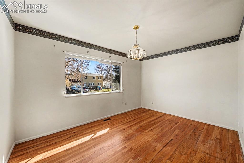 Image 8 of 45: Primary Bedroom With Hardwood Flooring