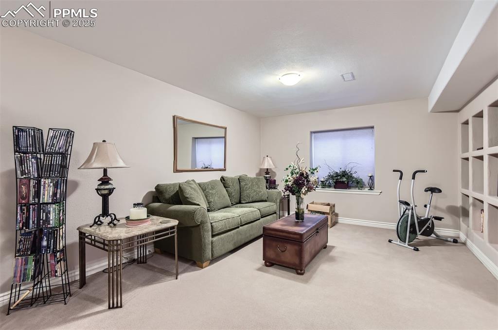 Image 25 of 28: Living room with carpet floors