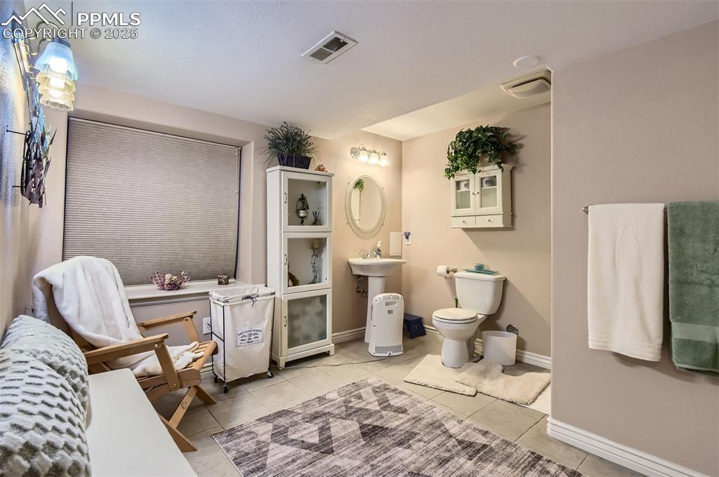Image 26 of 28: Bathroom with tile patterned floors and toilet