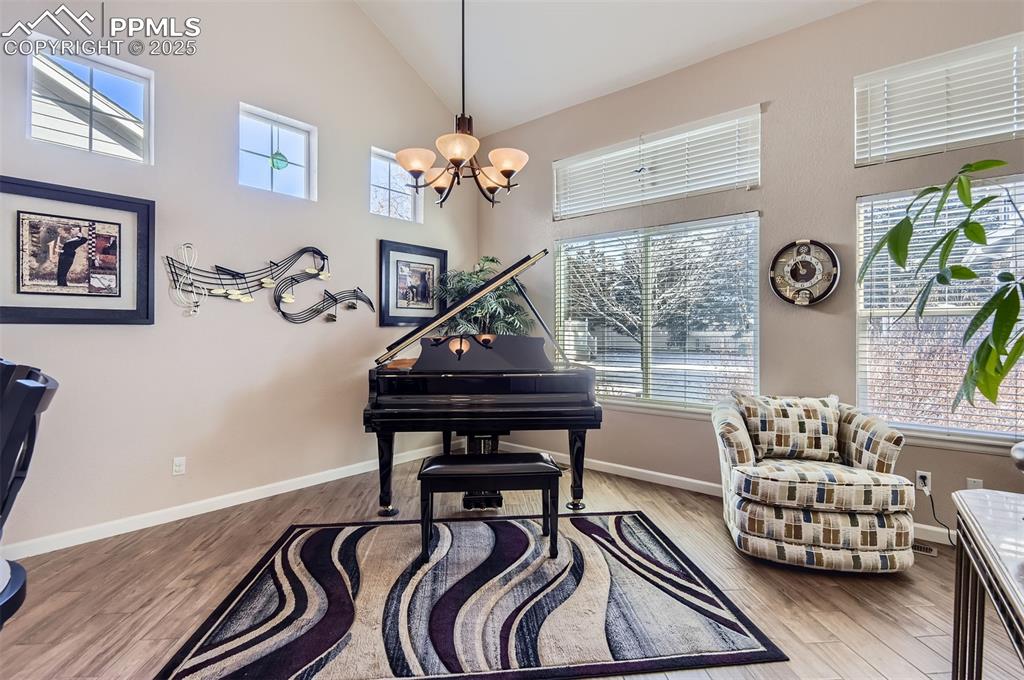 Image 8 of 28: Sitting room featuring high vaulted ceiling, light hardwood / wood-style fl