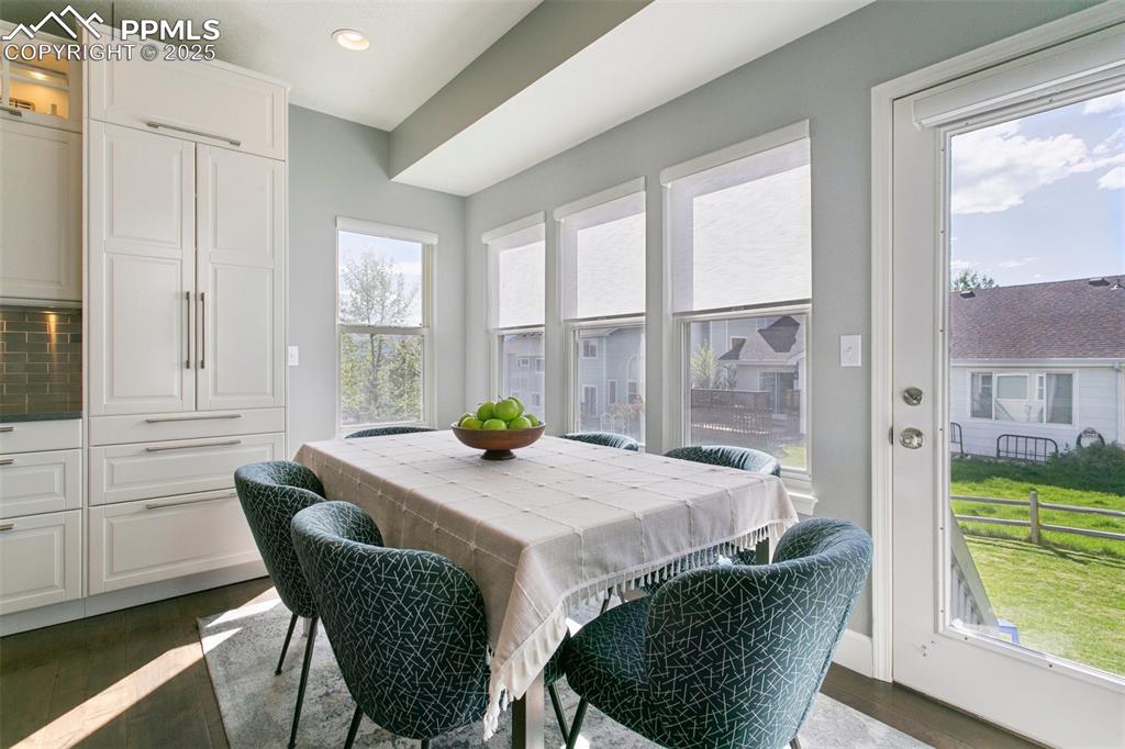 Image 18 of 50: Casual dining nook overlooking the backyard w/Air Force Academy view in the
