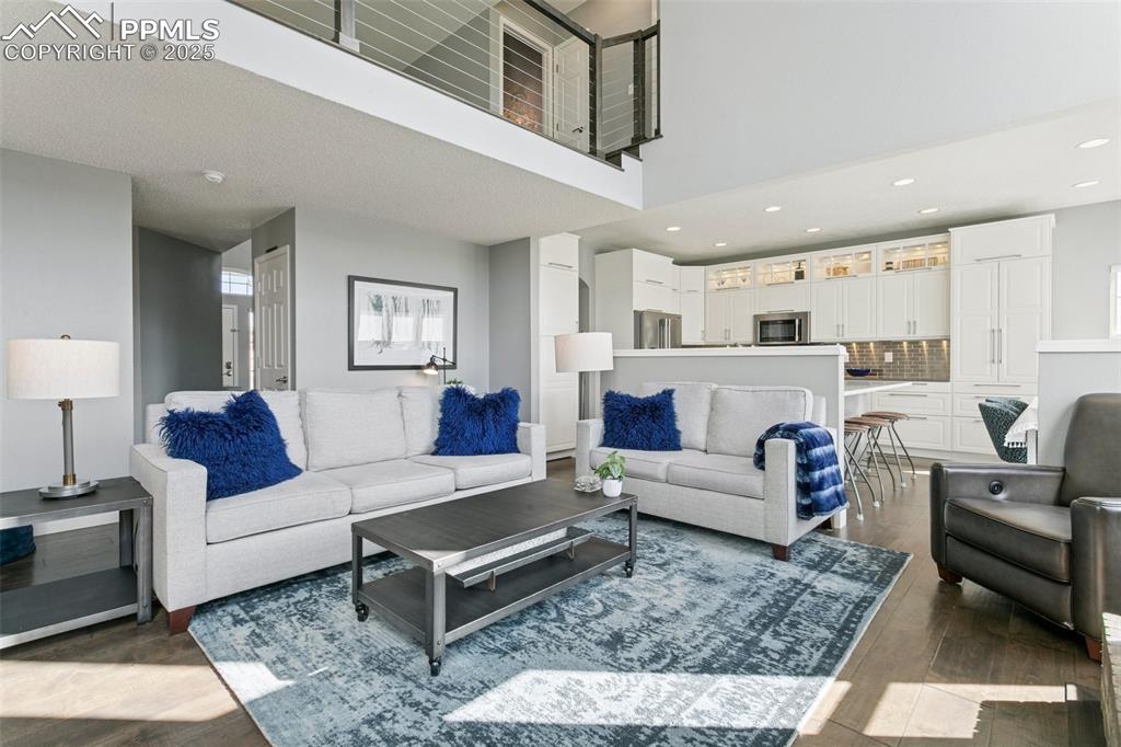 Image 19 of 50: Main level family room with soaring ceilings and plenty of space for furnit