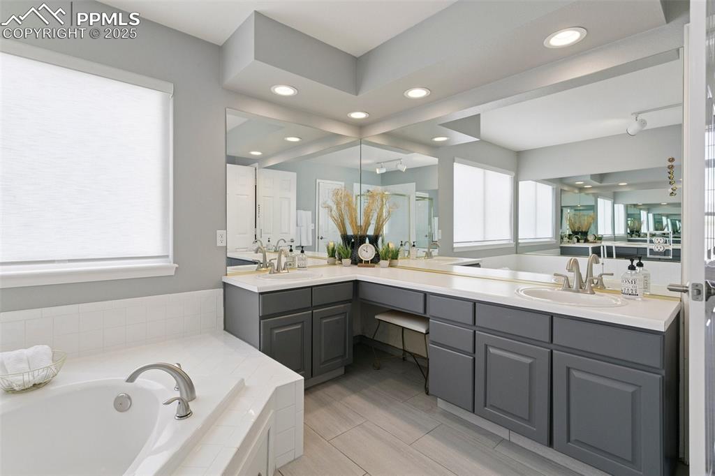 Image 33 of 50: Double vanity with tons of counter space and a bench seat!