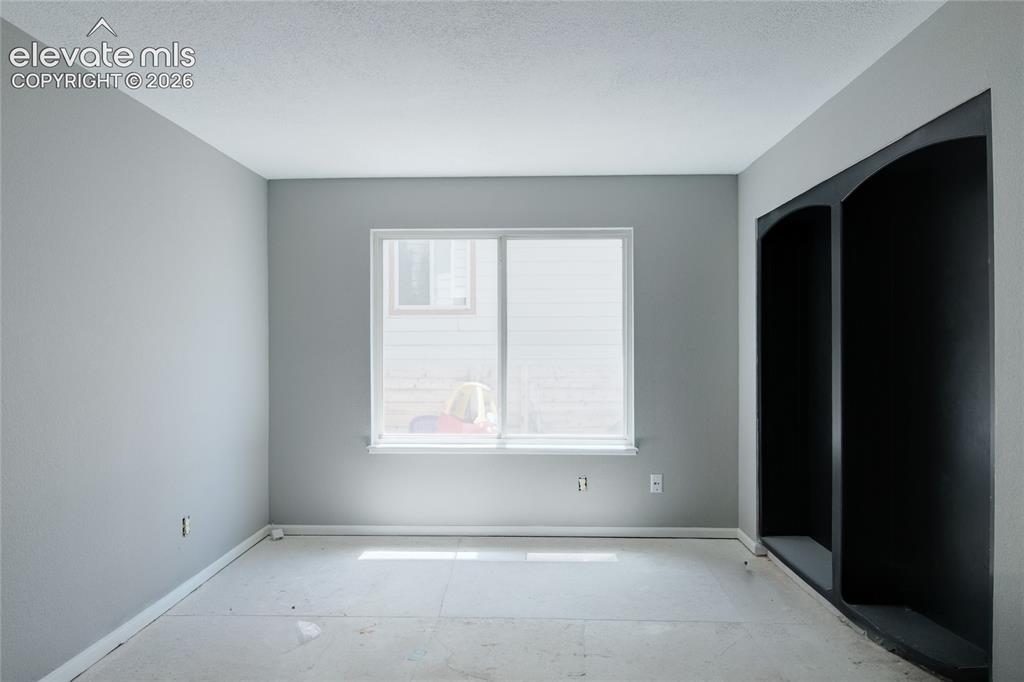 Image 18 of 28: Main-level study with built in bookcases. Can be used a guest bedroom.