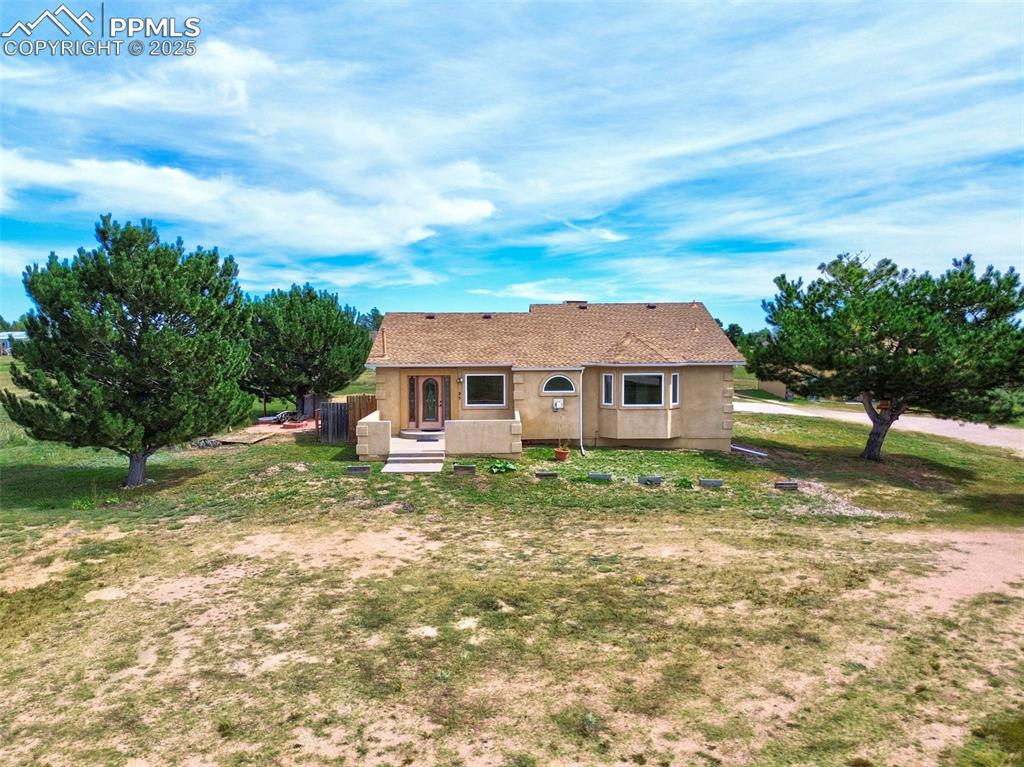 Image 41 of 50: View of front of home with stucco siding, roof with shingles, and a front l