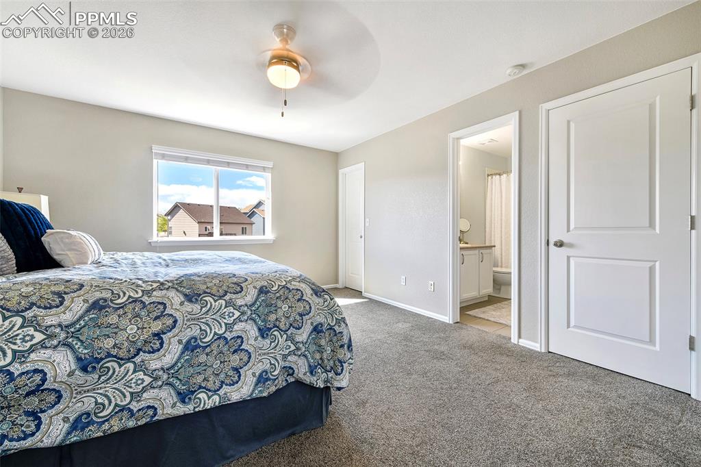 Image 16 of 46: Ensuite bathroom and closet and window with Pikes Peak view