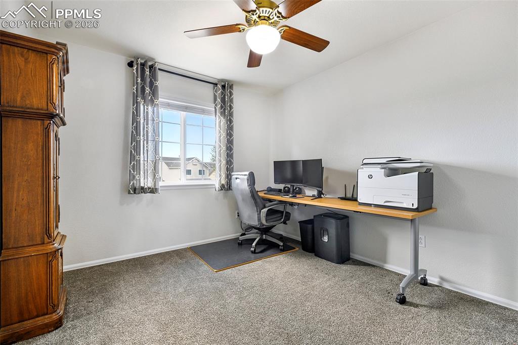 Image 21 of 46: Upstairs 4th bedroom, currently used as a home office, offering flexible sp
