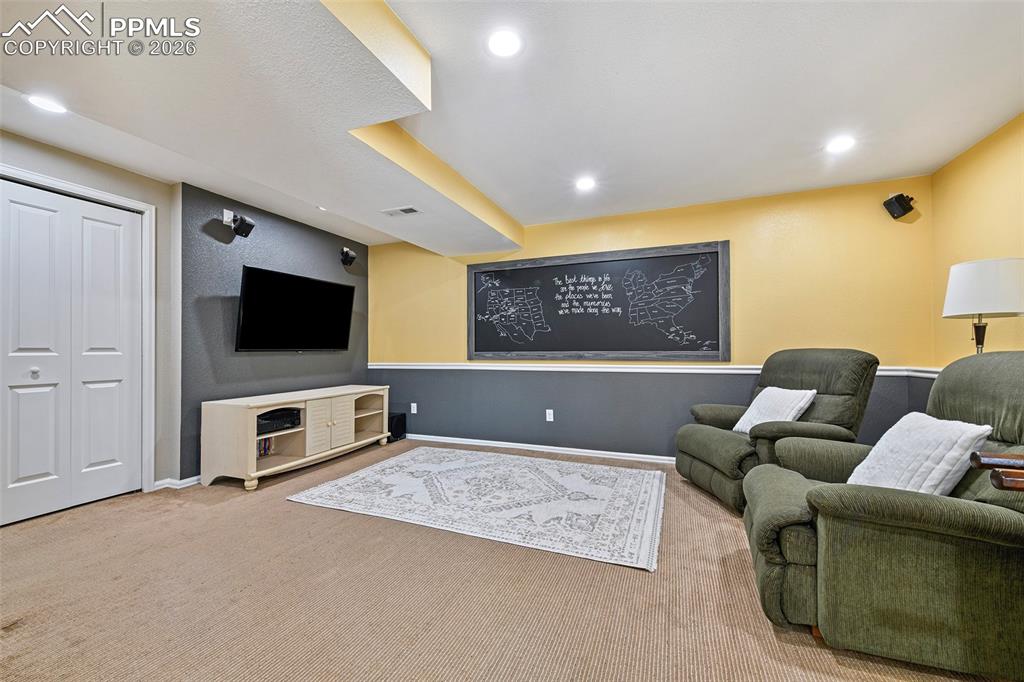 Image 23 of 46: Spacious basement media room with large storage closet