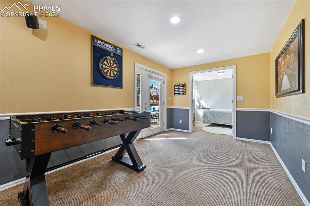 Image 26 of 46: Area for games and more with access to the patio and backyard