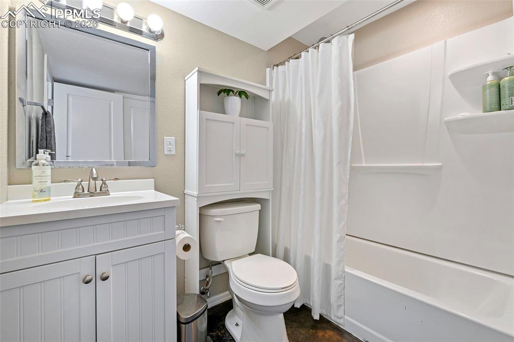 Image 28 of 46: Full large bathroom, including a closet and access to a large storage area